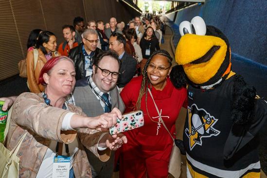 Attendees posed with Iceburgh, mascot of the Pittsburgh Penguins, at the Host Company Reception (photo: David Bachman Photography)