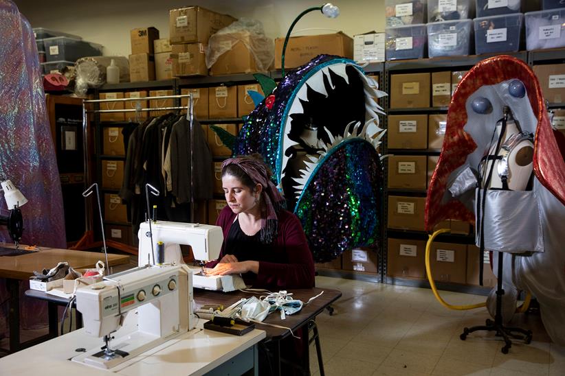 Corinna Bakken sews masks in Minnesota Opera’s costume shop.